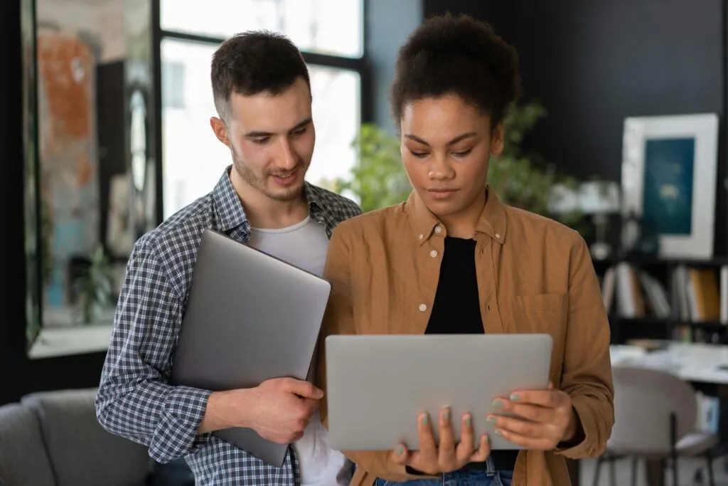 Business partners reviewing plans on a laptop